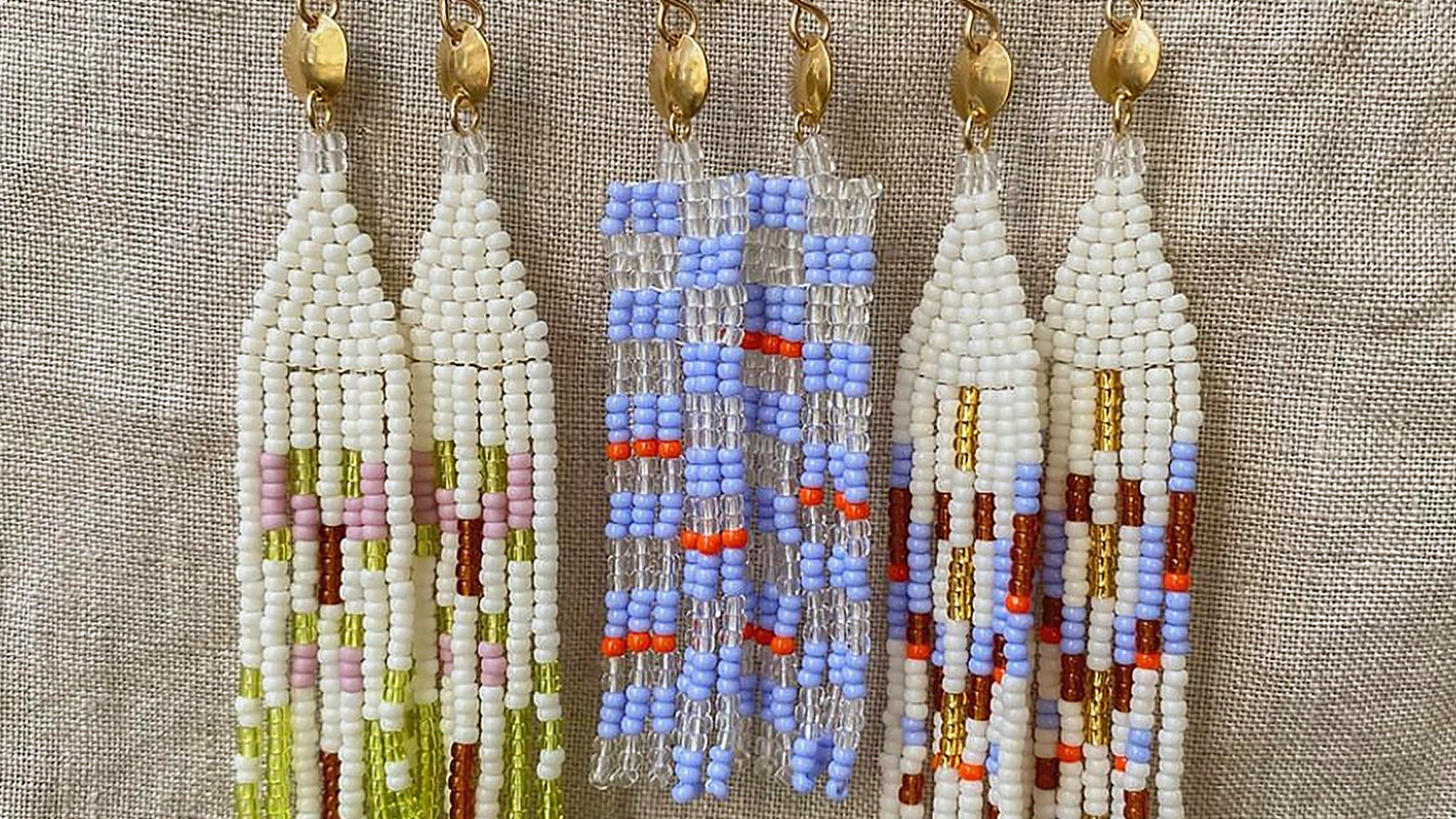 Glass seed beaded earrings with multiple colors like blue red and white in Native American style